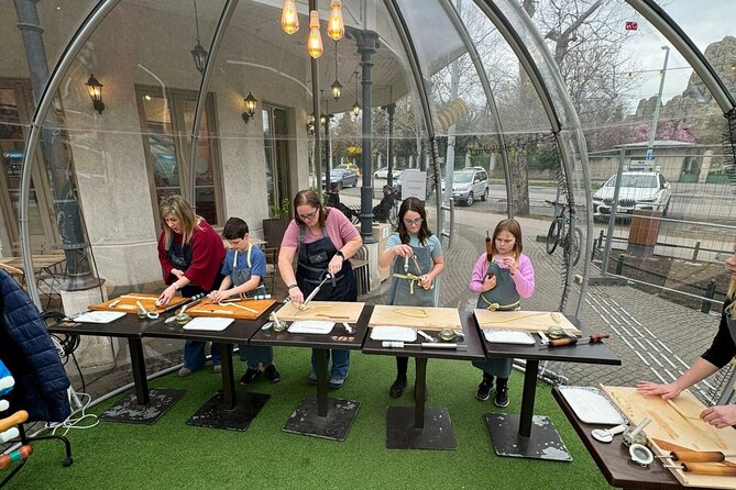 Kürtőskalács: Chimney Cake Workshop in City Park Budapest - Baking three small Kürtőskalács