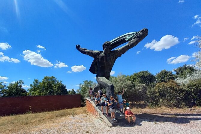 Minivan to Communist Statues and Memento Park with Live Guide - Taking photos beside failed political symbols